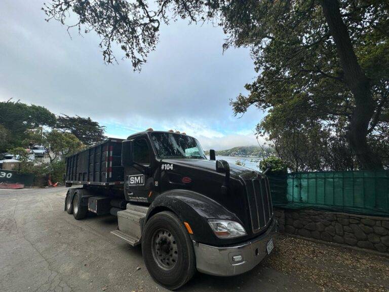 SMI crew loading demolition debris into a dump truck
